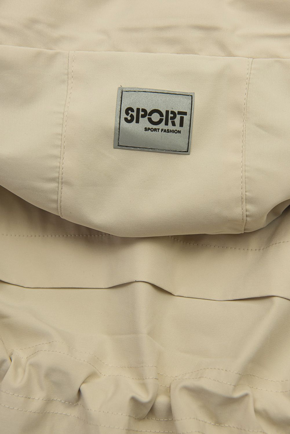 Bézs színű átmeneti parka derékban behúzással
