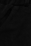 Fekete színű laza nadrág derekán gumival